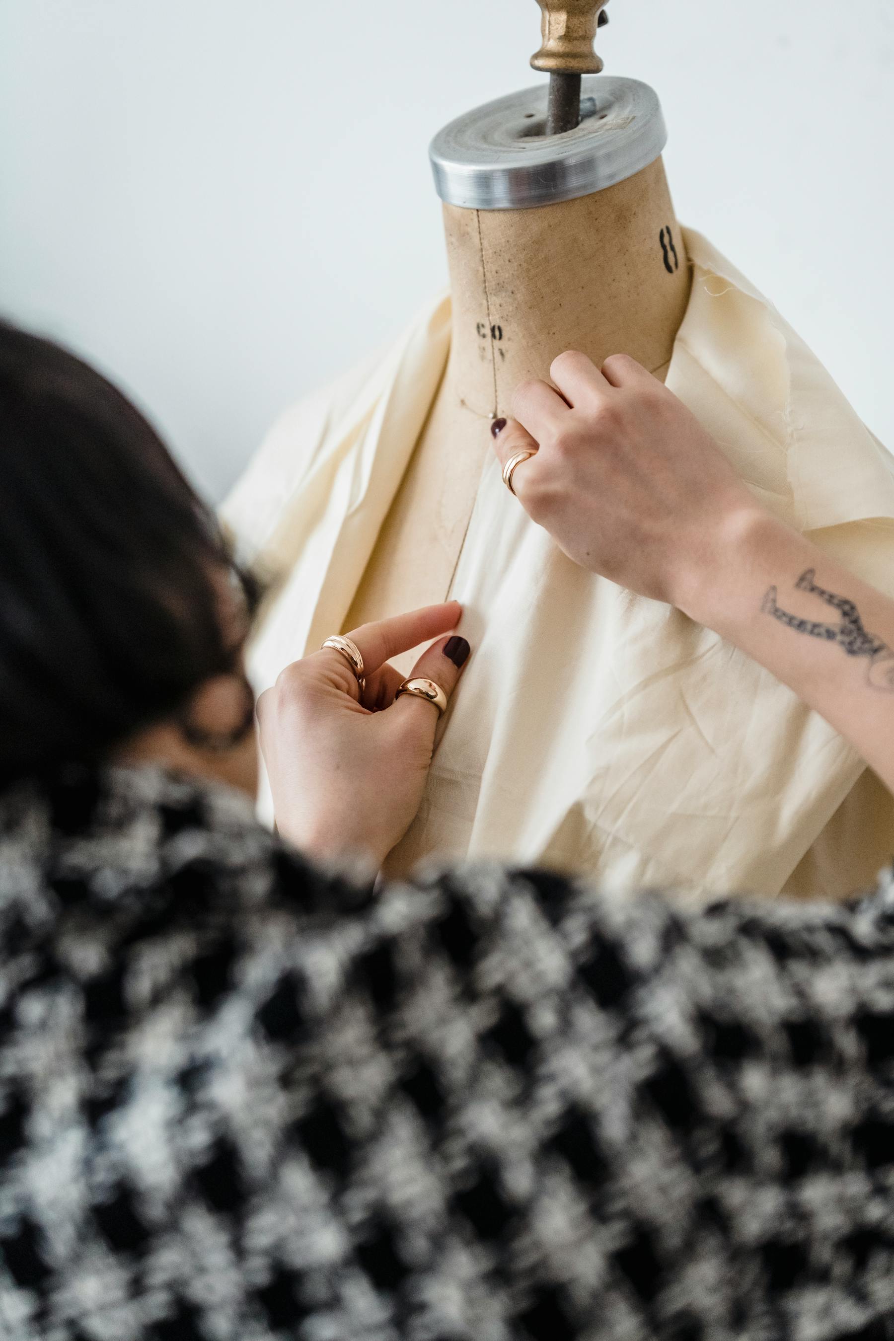 Fabric draped over a dress form during costume fitting work.